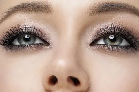 Oczy z perfekcyjnym makijażem smokey eyes, długimi rzęsami i subtelnym połyskiem na powiekach.